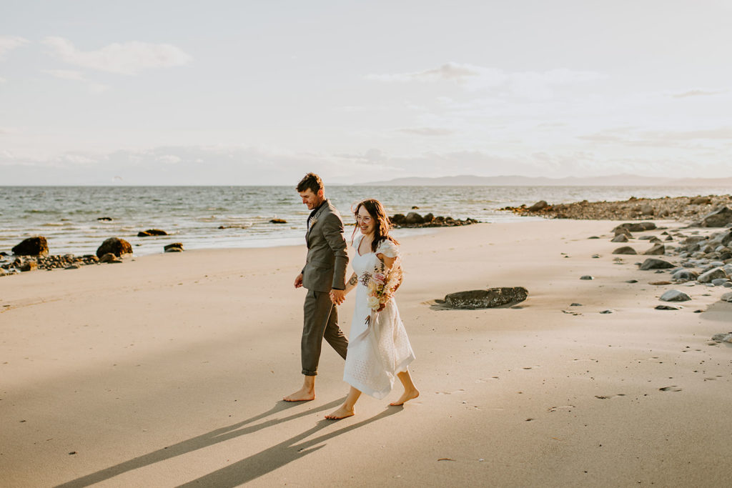 Couple walking down the beach on Thormanby Island during their BC elopement package