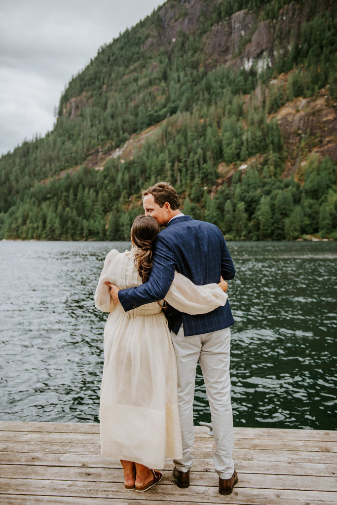 Couple celebrating on the dock at Chatterbox Falls  during their British Columbia Elopement Package.