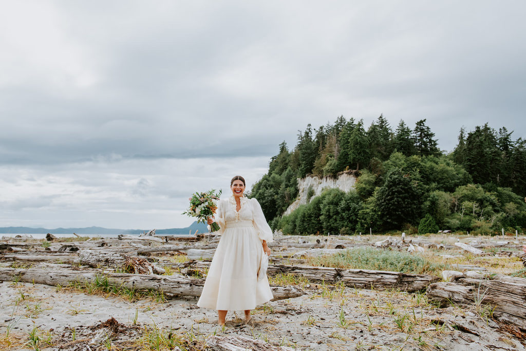 Bride standing on the sandy shores of Thormanby Island during her British Columbia Adventure Elopement Package