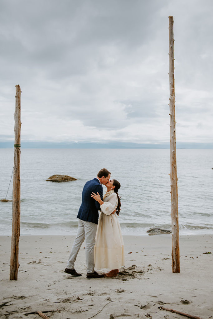 Couple during their wedding ceremony on the sandy shores of Thormanby Island during their British Columbia Adventure Elopement Package