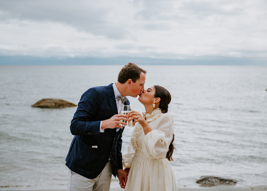 Couple kissing on the sandy shores of Thormanby Island during their British Columbia Adventure Elopement Package