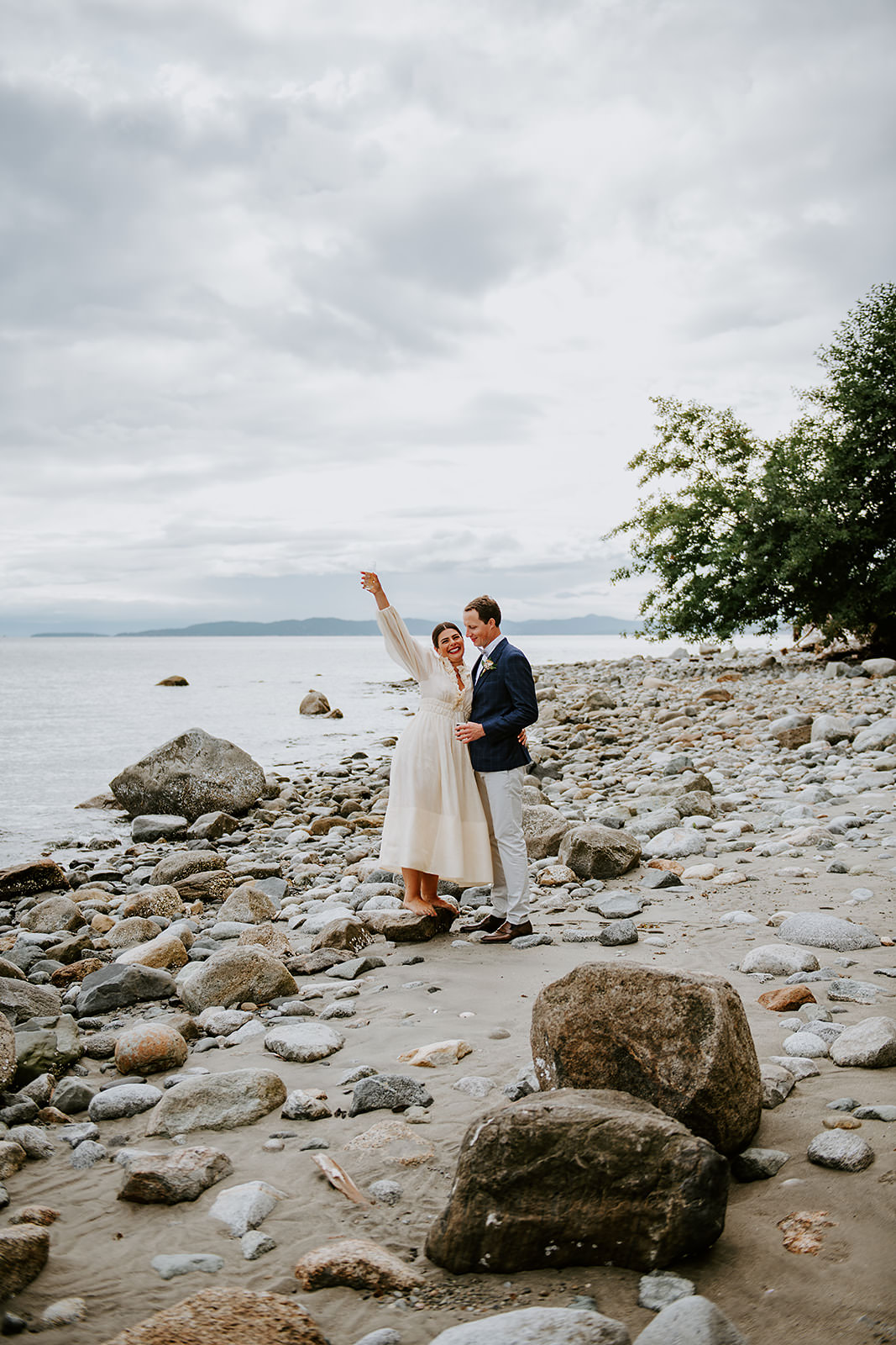 Couple celebrating on the sandy shores of Thormanby Island during their British Columbia Adventure Elopement Package