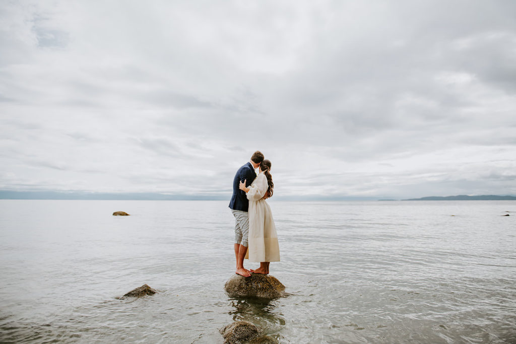 Couple posing for wedding portraits on the sandy shores of Thormanby Island during their British Columbia Adventure Elopement Package